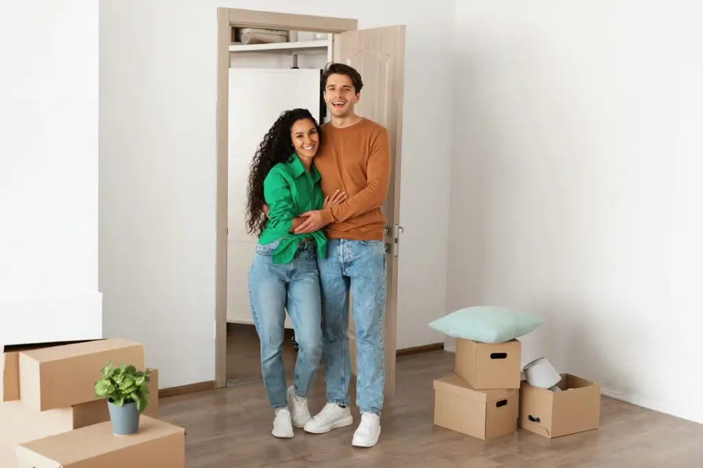 Happy man and woman posing on moving day