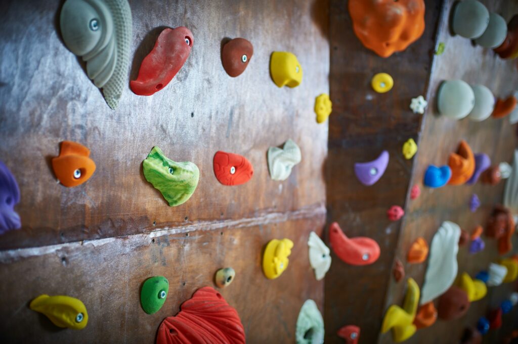 Wooden wall with climbing holds in gym